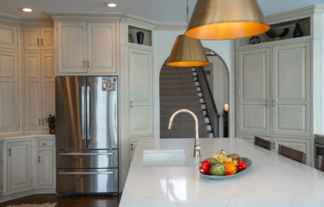 Kitchen with stainless steel fridge and pendent lighting