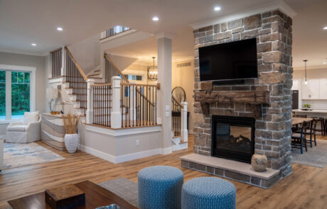 Living room with fireplace overlooking the grand staircase